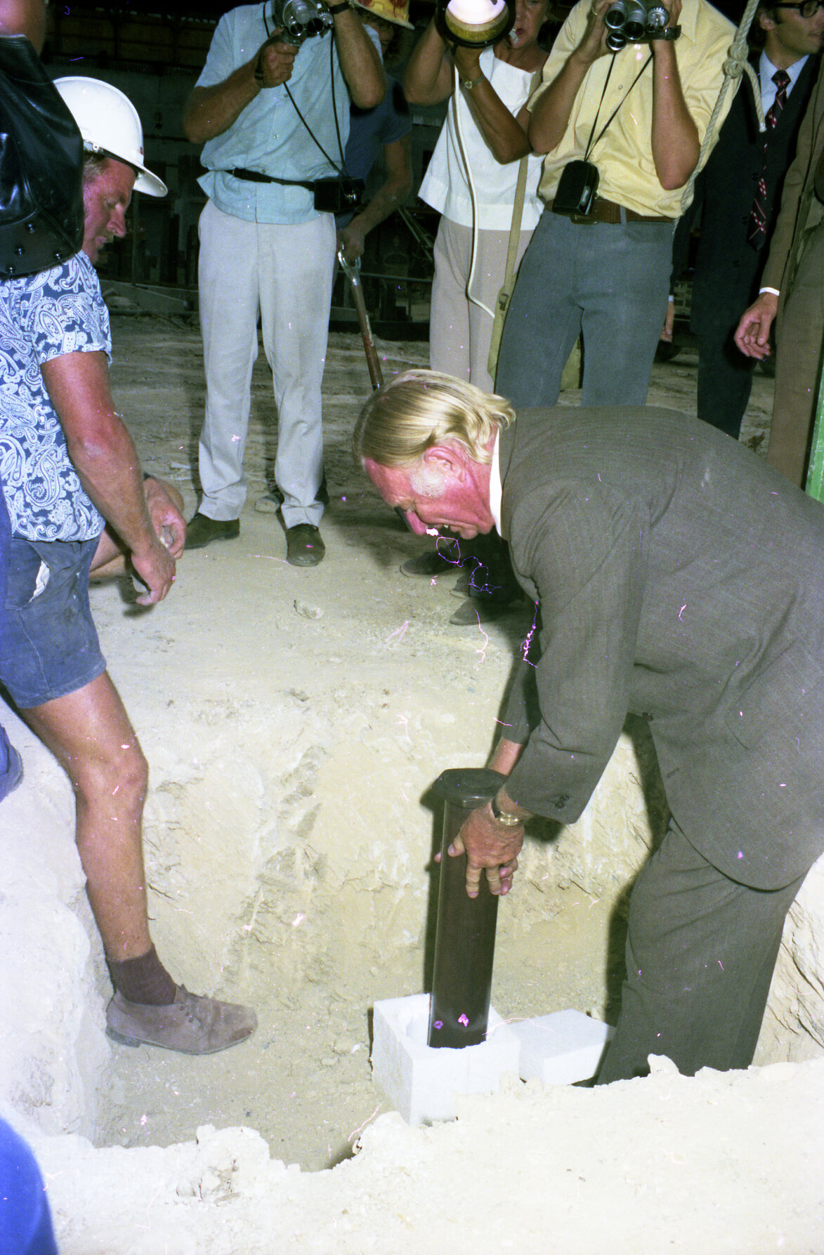 Lord Mayor Clem Jones placing time capsule in Brisbane Administration Centre construction site - 1974