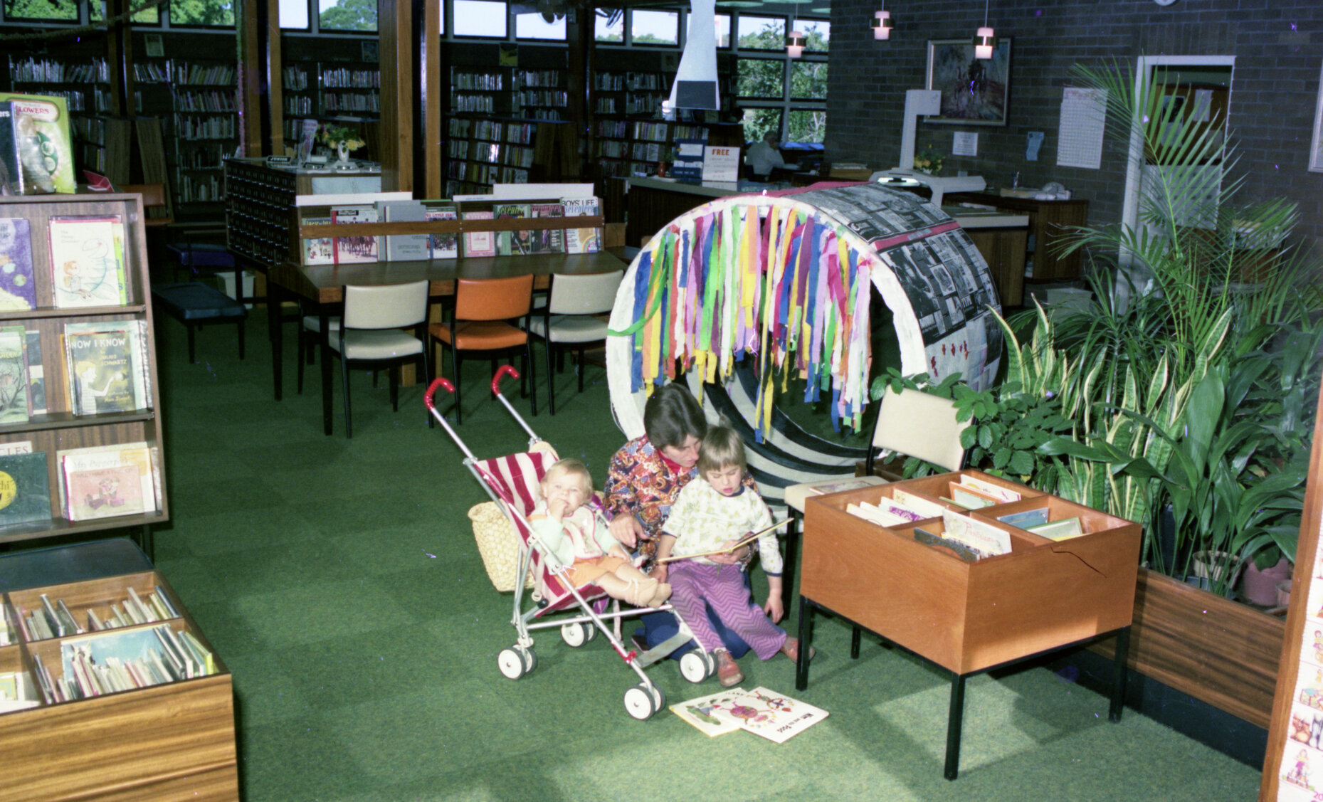 Mother and children reading books at New Farm Library - 1976