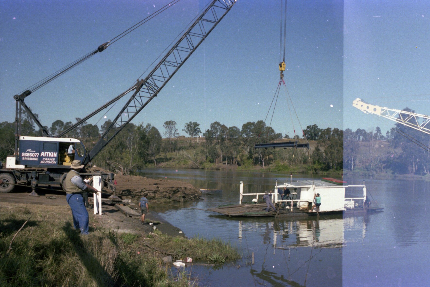 Moggill Ferry being lifted by crane from river for maintenance - 1978
