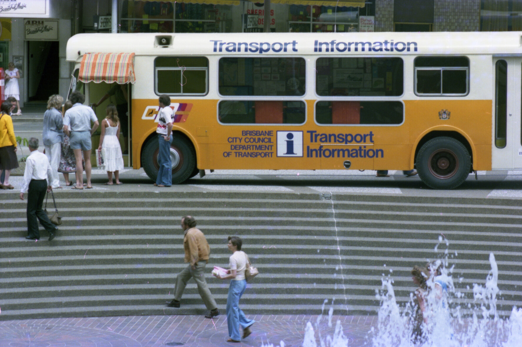 Bus with transport information desk at City Plaza on corner of Ann and George Streets, Brisbane City - 1978