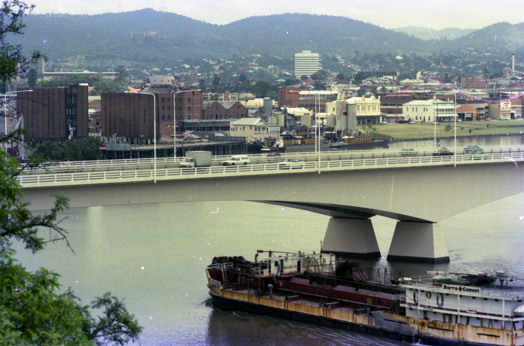 Sea Foam Flour Mill being demolished with view of Victoria Bridge and Darra Cement bulk hauler, South Brisbane - 1979