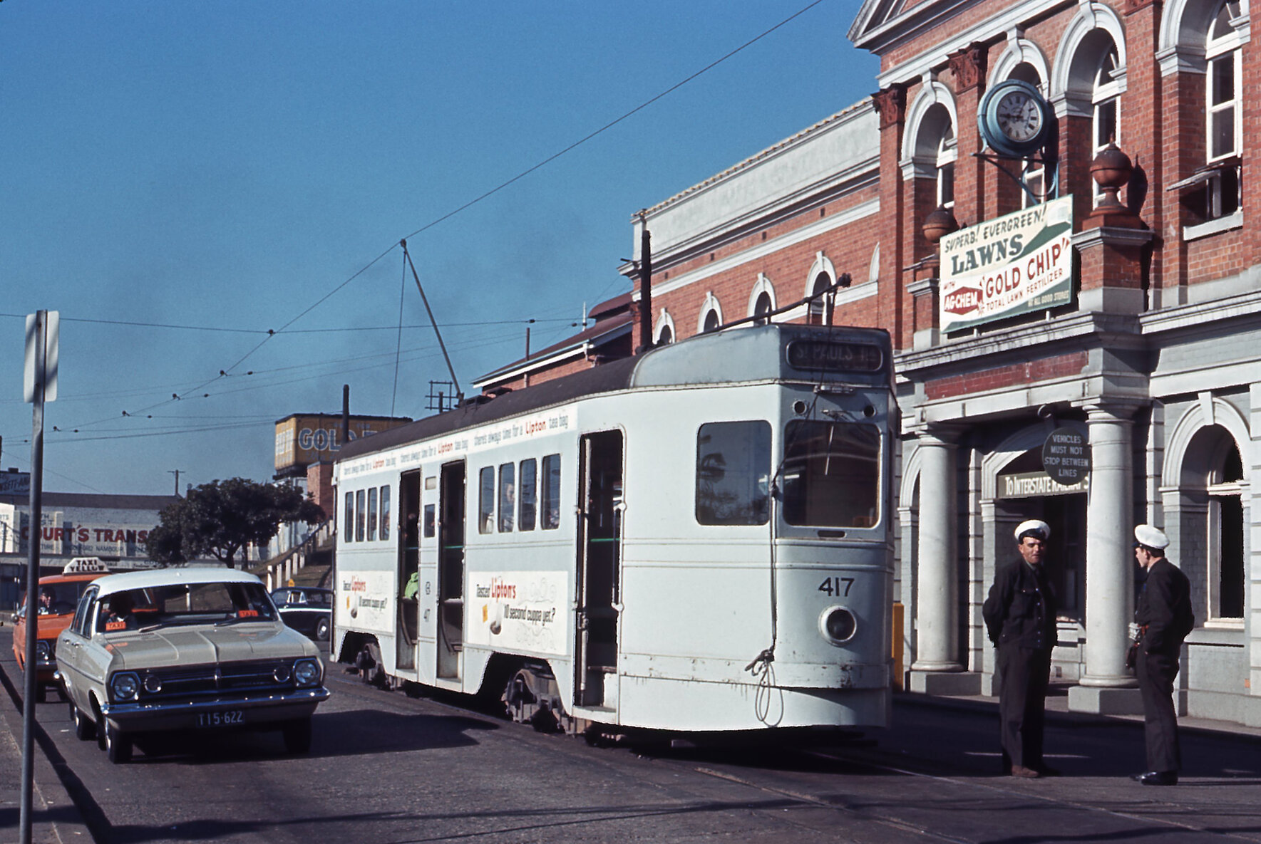Tram drivers talking outside South Brisbane Station with tram No. 417 - 1964