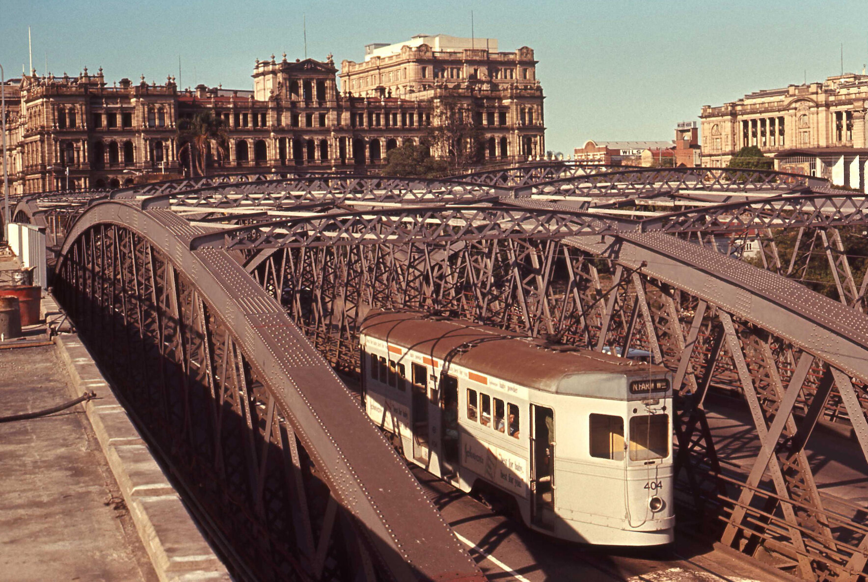 Tram No. 404 crossing Victoria Bridge with Treasury Building, Land Administration Building, and Family Services Building - 1969
