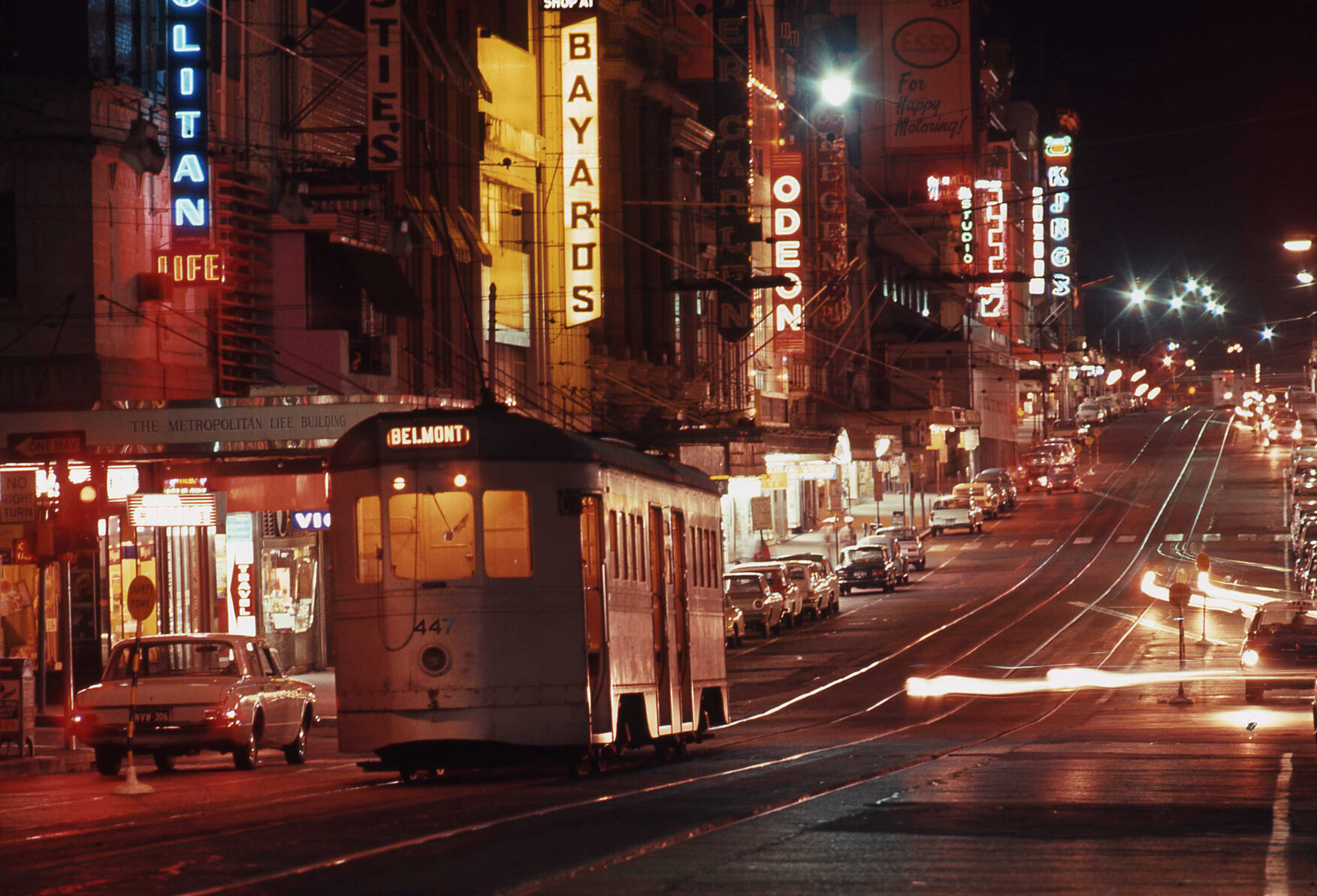 Tram No. 447 on Queen Street from Edward Street lit up with neon signs - 1969