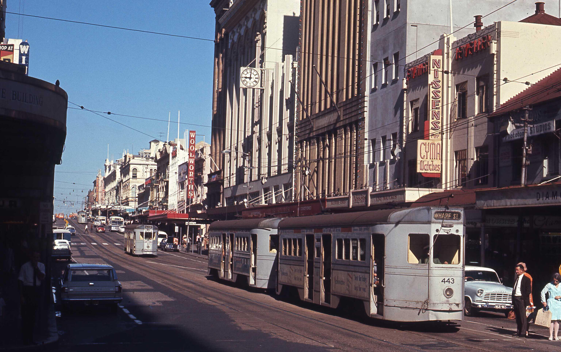 Trams No. 443, No. 413 and a Leyland Panther bus on corner of Queen and Edward Streets, Brisbane City - 1969
