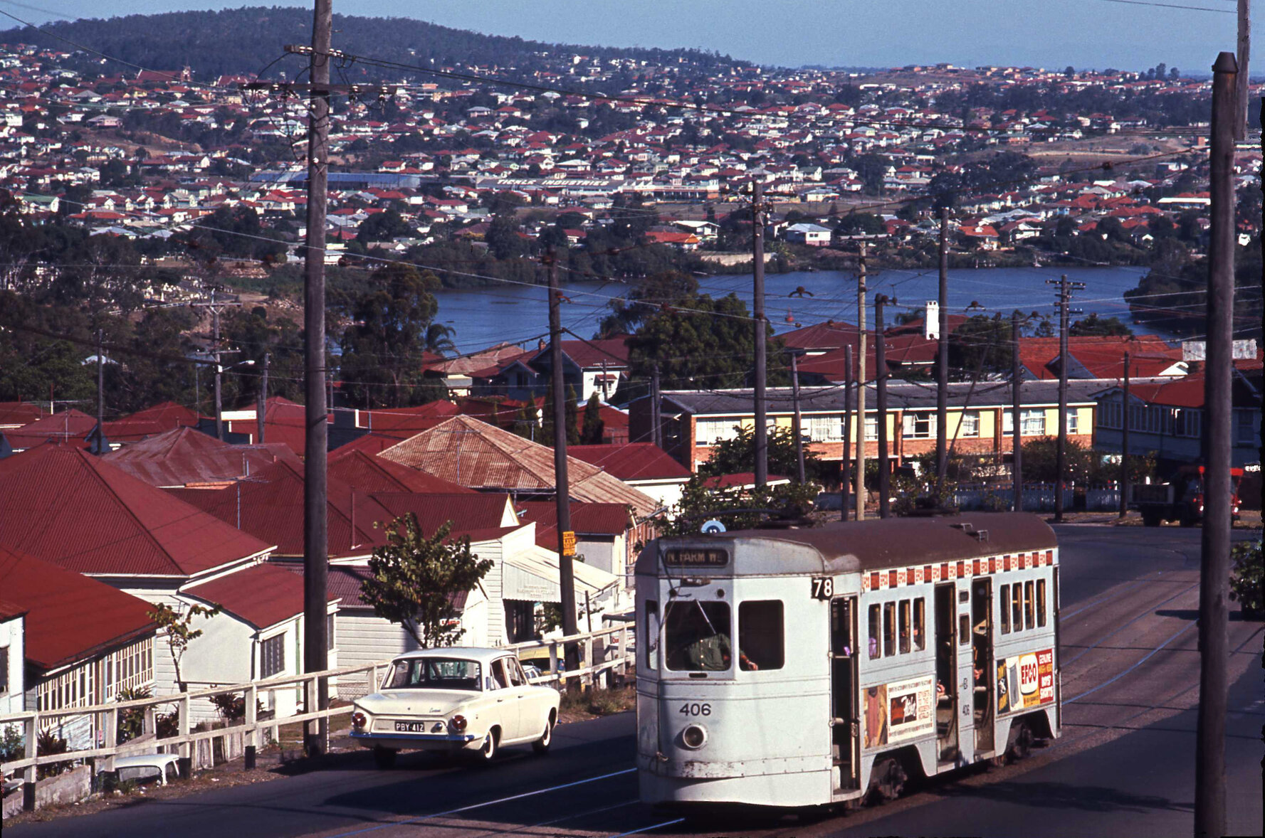 Landscape shot of tram No. 406 on Gladstone Road possibly near Beaconsfield Street, Highgate Hill - 1969