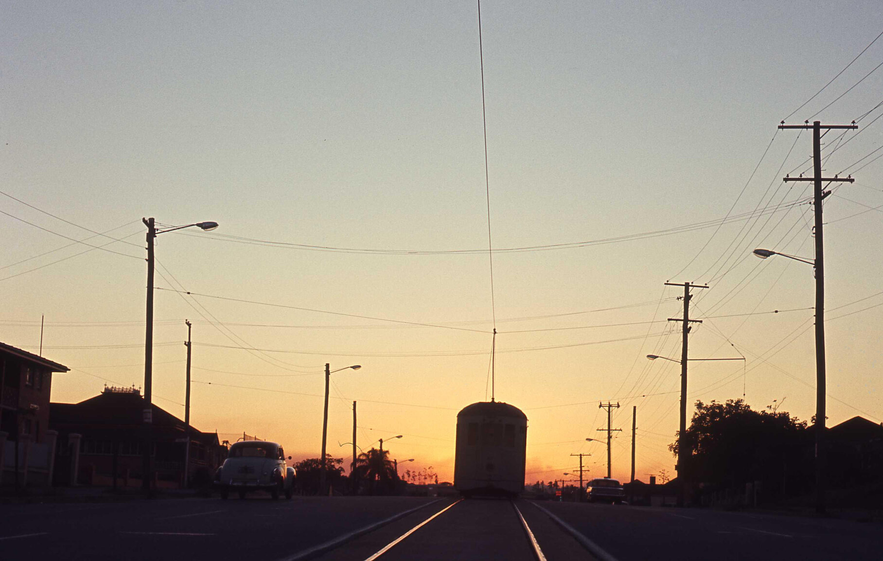 Shot of tram No. 411 on O'Keefe Street at sunset, Woolloongabba - 1969