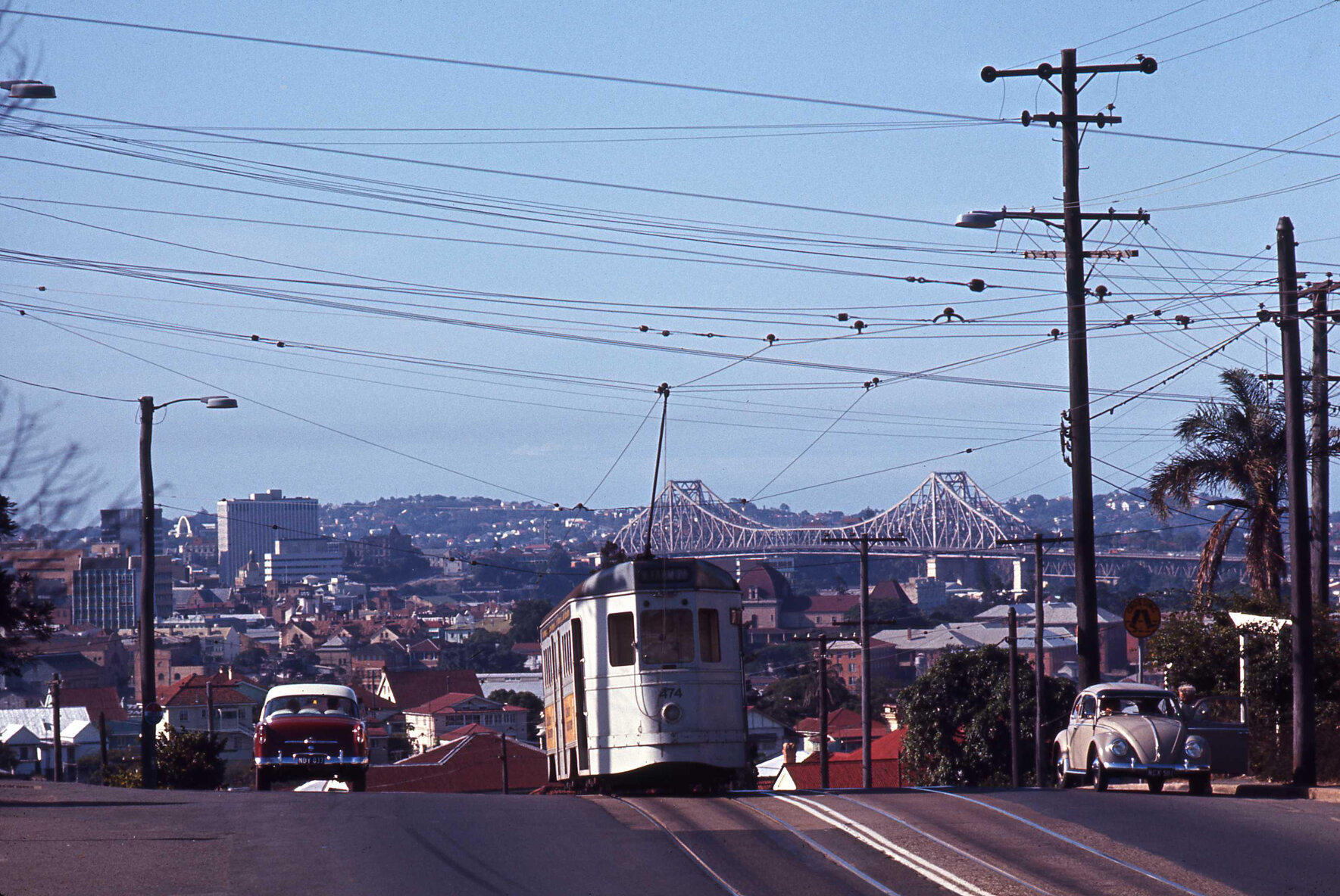 Tram No. 474 cresting hill on Gladstone Road with view of Story Bridge, Highgate Hill - 1969