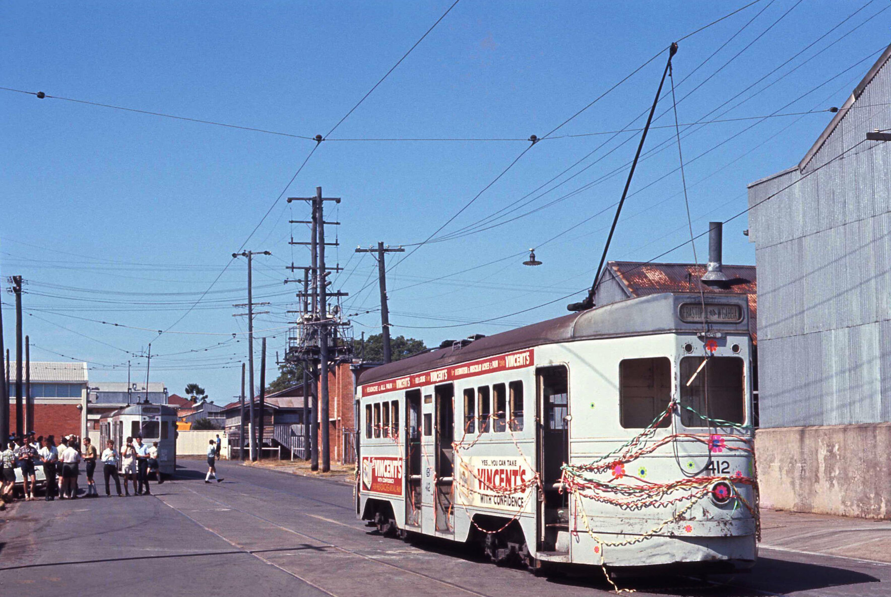 Tram No. 412 painted with flowers and covered with ribbons, No. 531 in background on Trafalgar Street, Woolloongabba - 1969