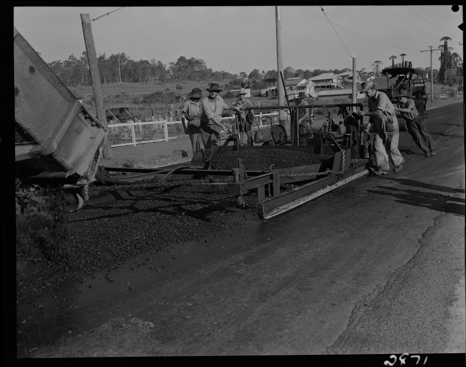 Work crew spreading asphalt - 1952