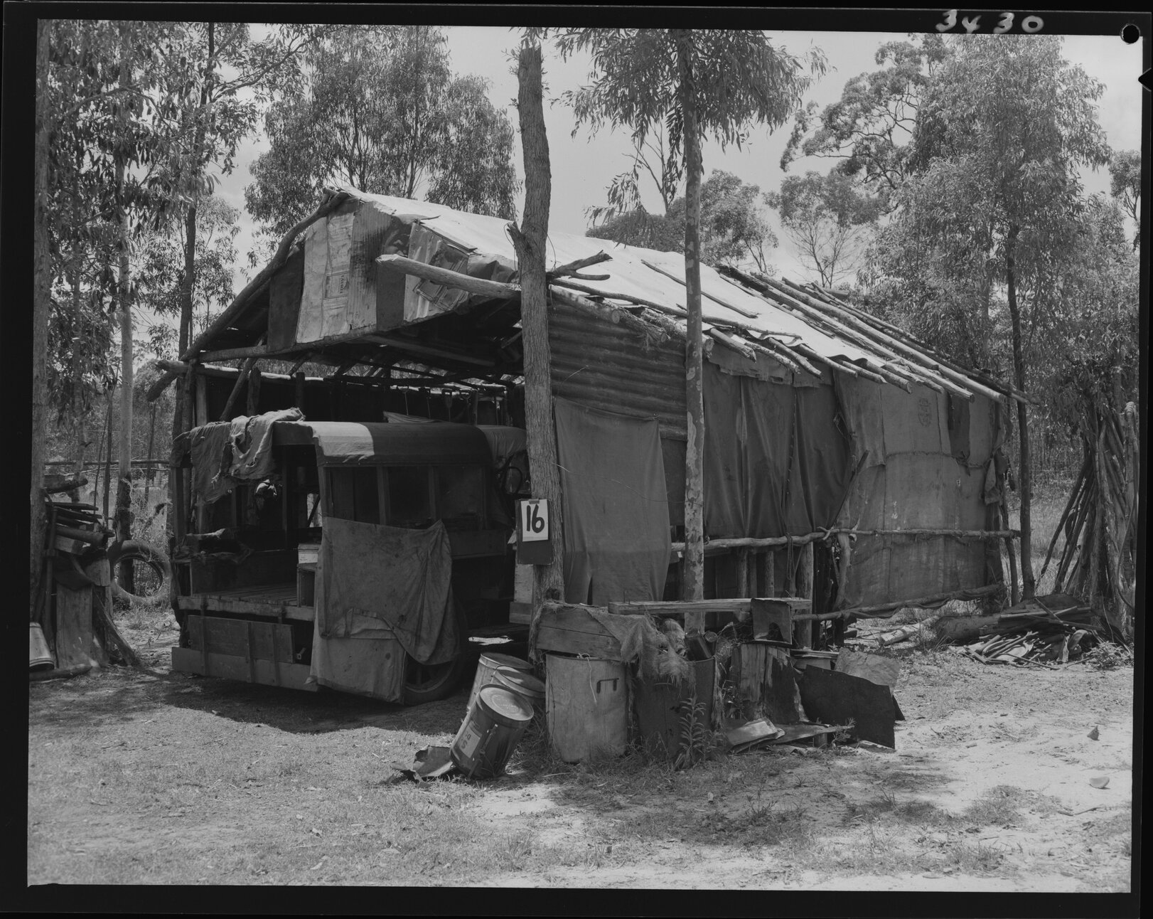 Temporary house labelled 16 with truck parked inside Wacol - 1953