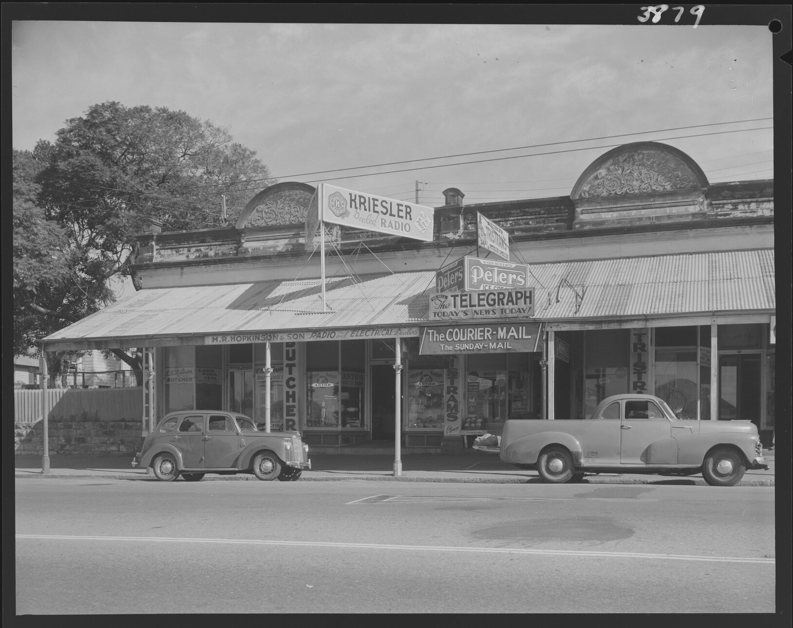Building facade of displaying advertising and signs for ESR Laren Butcher and Hopkinson and Son Radio and Electrical Dealers - 1953