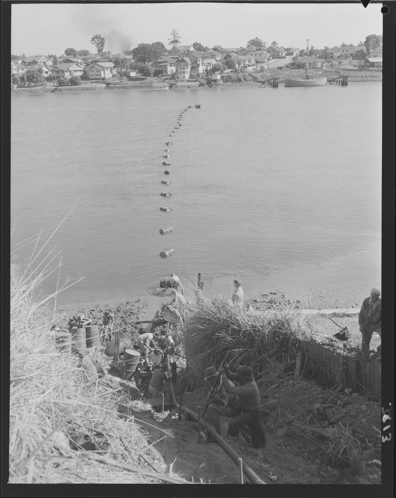 Workmen laying electrical cable across the river from Kangaroo Point to New Farm - 1953
