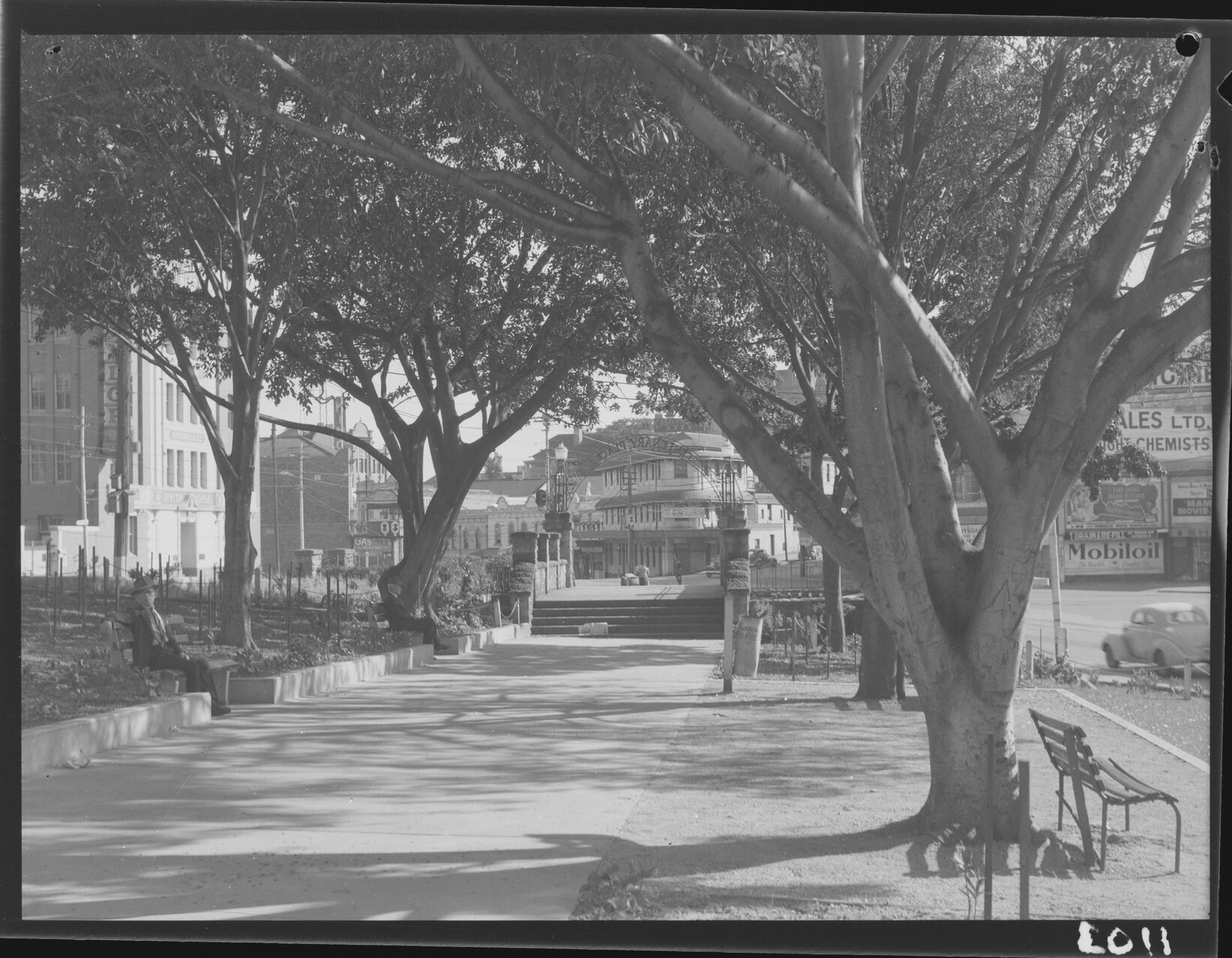 Man in hat resting at Centenary Place Park - 1950