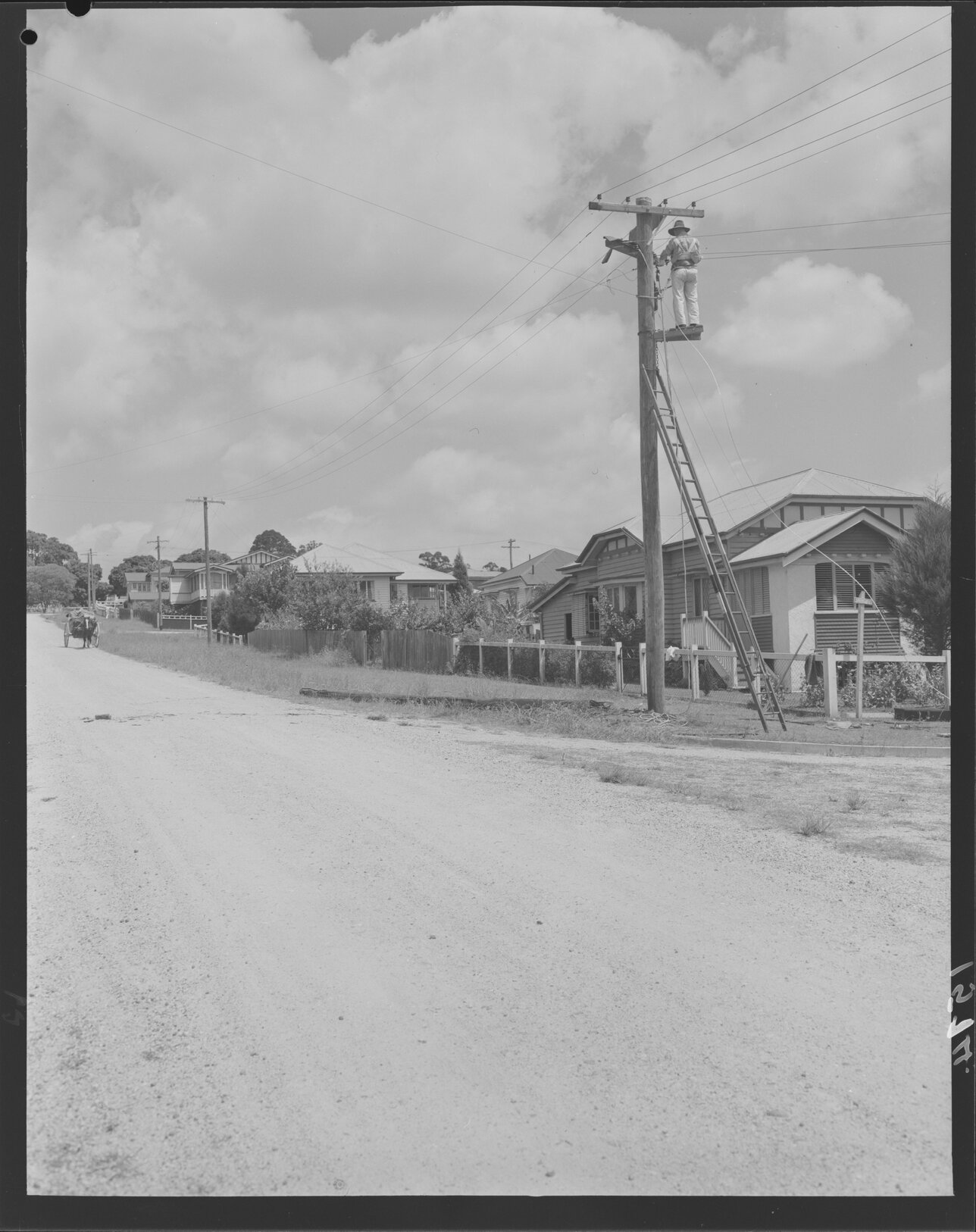 Linesman stringing new electricity wires at Sherwood - 1951