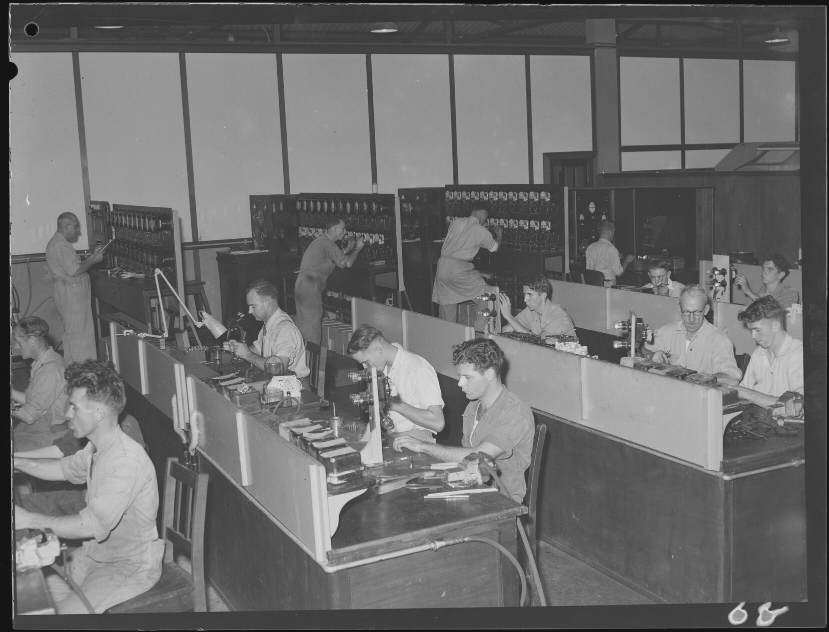Workers in a meter room for electricity meter testing on Abbotsford Road, Bowen Hills - 1949
