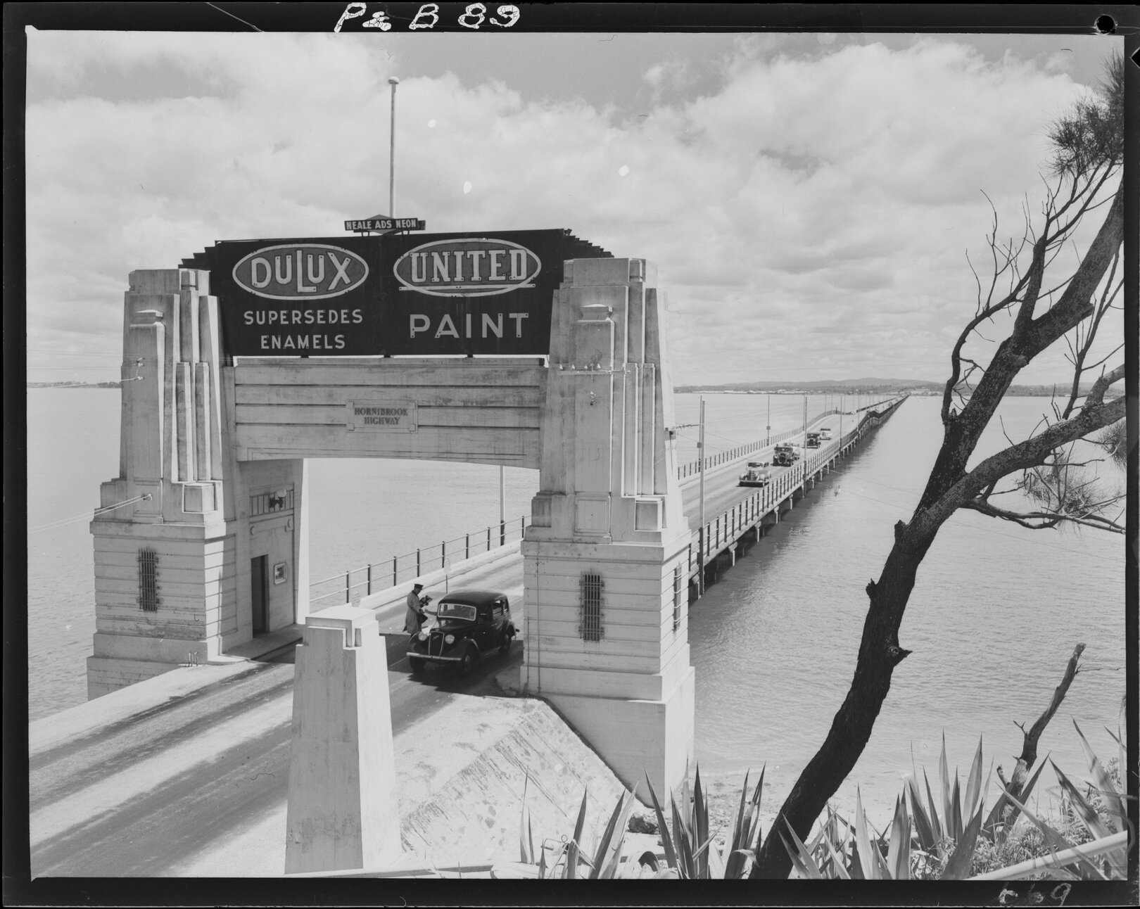 Hornibrook Highway overlooking the bridge, with Dulux paint advertisement,  Brighton - 1950