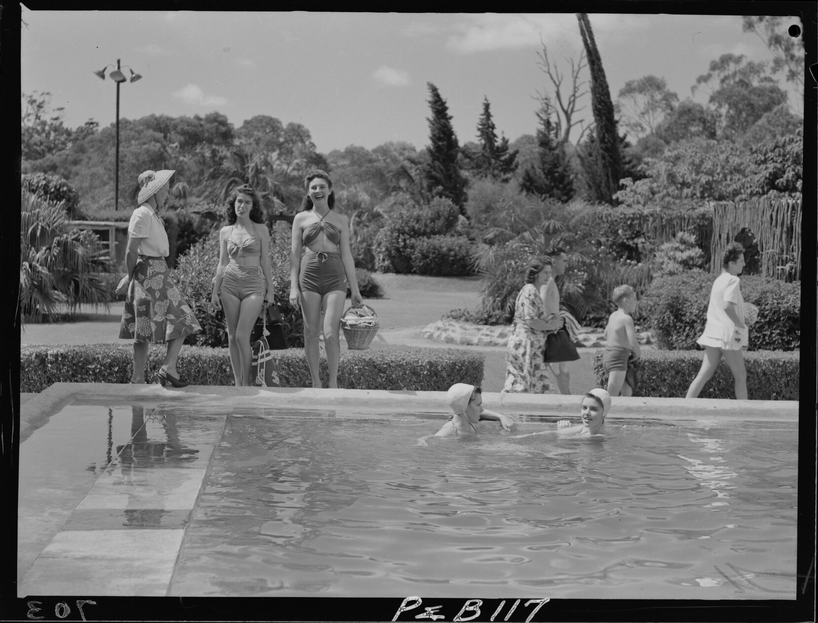 Swimmers enjoying the sunshine at Oasis Swimming Pool in Sunnybank - 1948