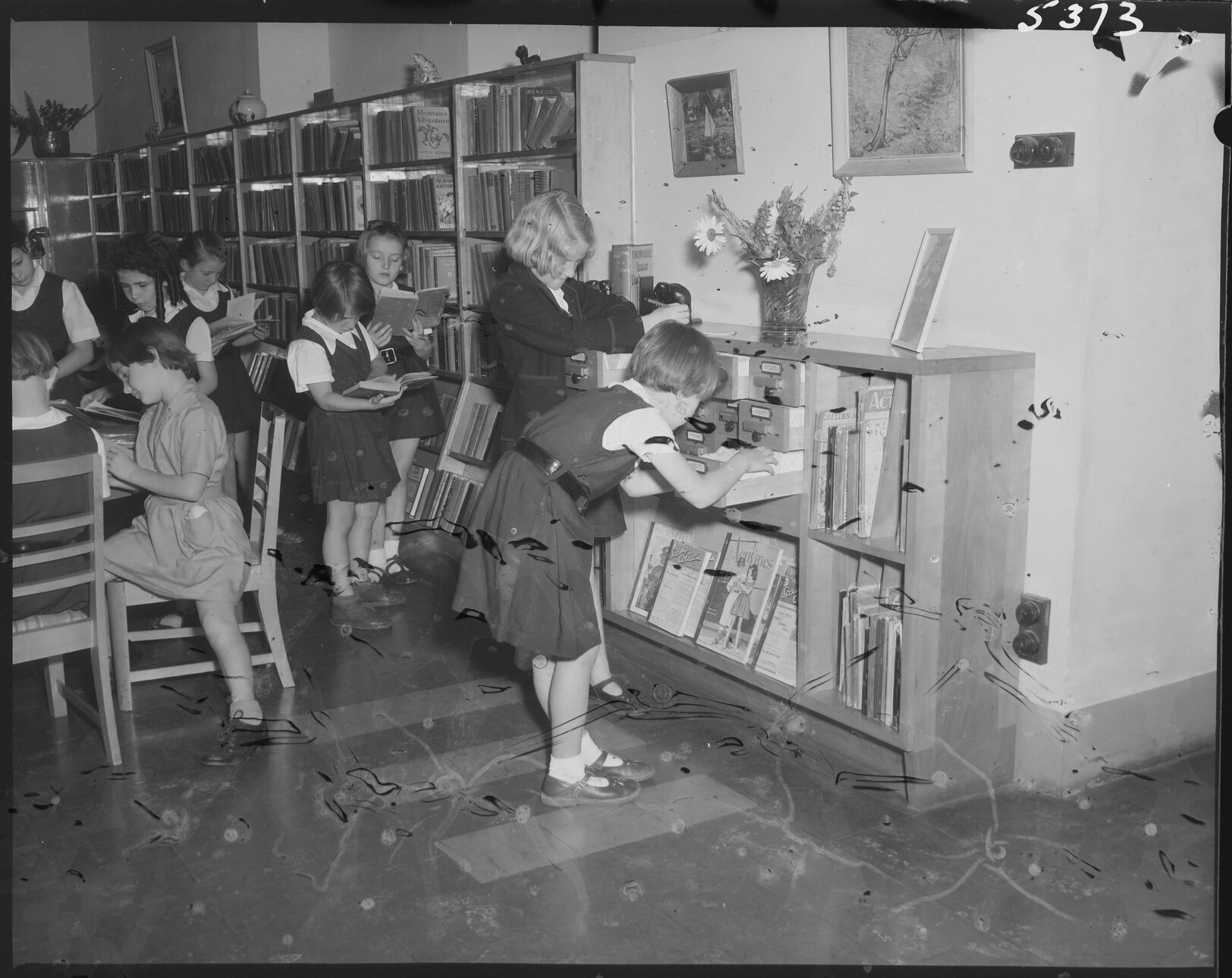 Young schoolgirls using the card catalogue, South Brisbane Children's Library - 1954
