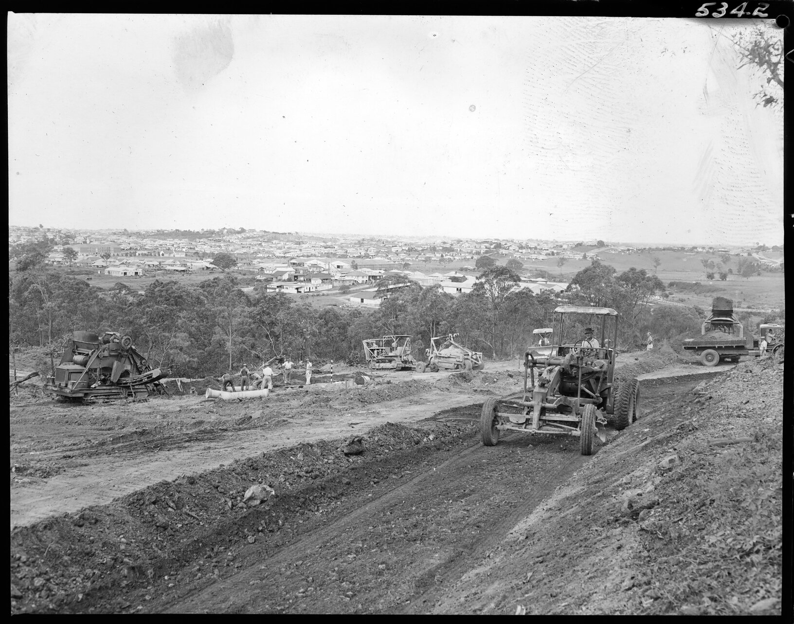 Workmen with heavy machinery on Raymont Road, Alderley and view of surrounding suburbs - 1954