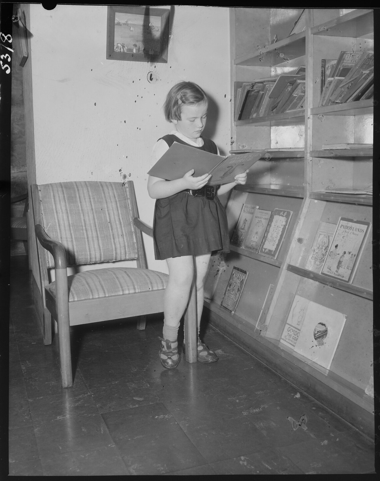 Young schoolgirl reading a book, South Brisbane Children's Library - 1954