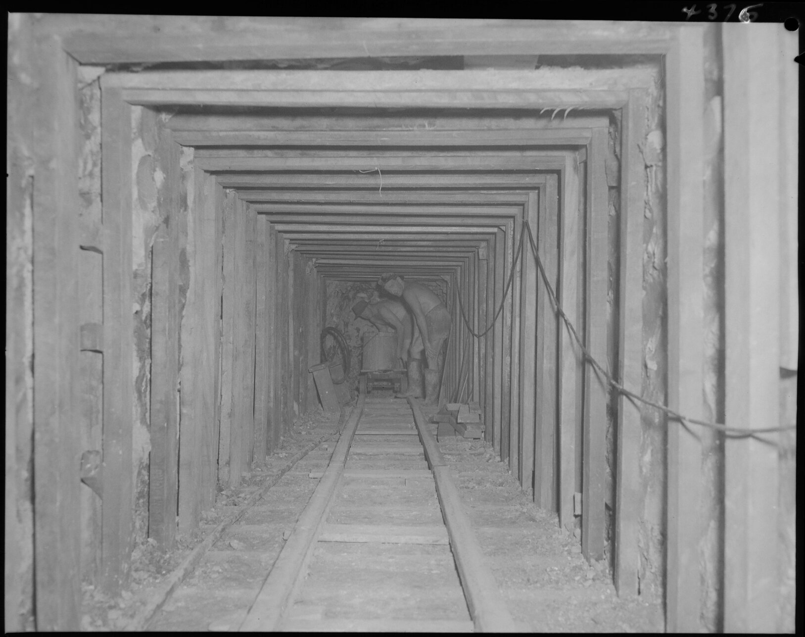 Two men in underground tunnel, Eagle Farm pipeline for pump station -1953
