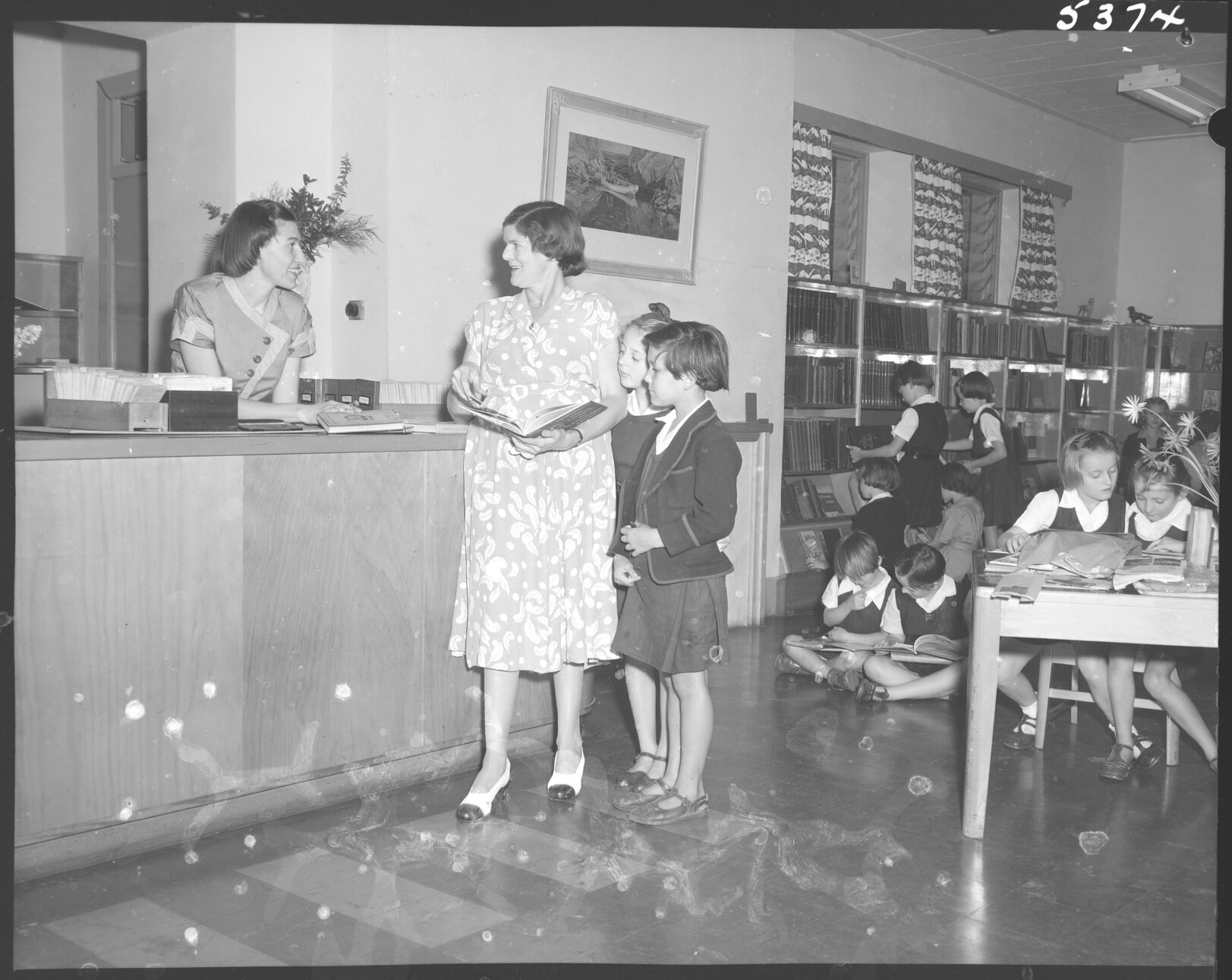 Customer requests at counter, South Brisbane Children's Library -1954