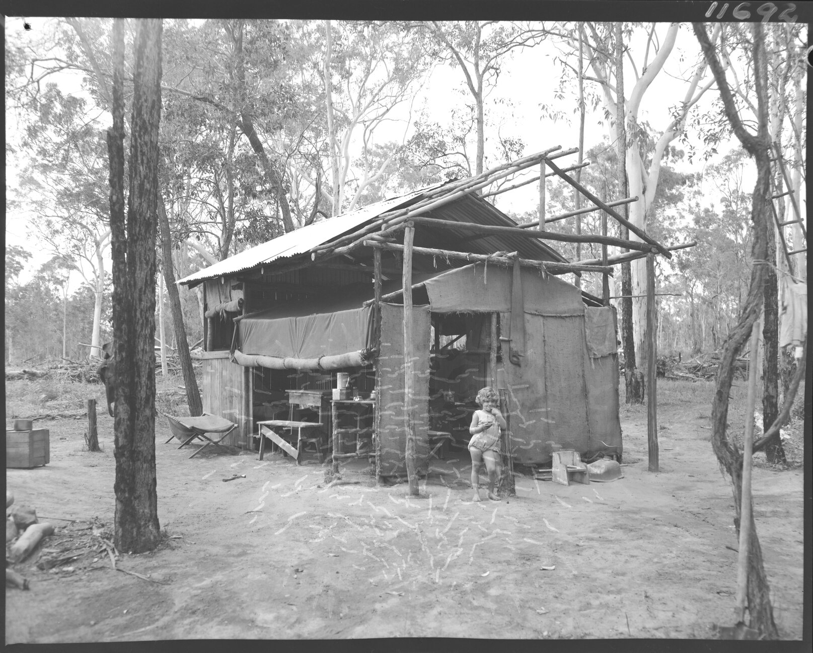 Temporary canvas dwelling with child, possibly Acacia Ridge, Salisbury or Rocklea - 1959