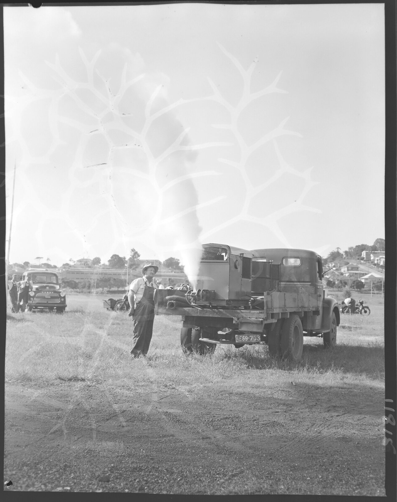 Council worker demonstrating mosquito fogging truck at racecourse, Eagle Farm - 1959
