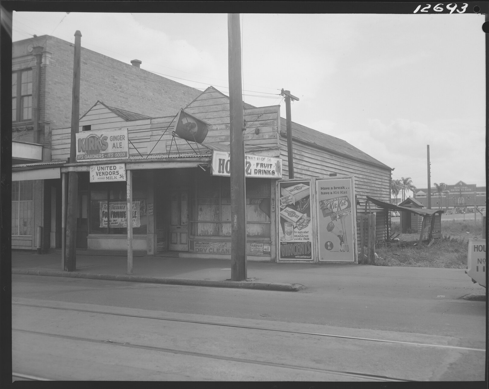 Boarded up shop on Ann Street, near East Street with Valley Baths in background, Fortitude Valley - 1959