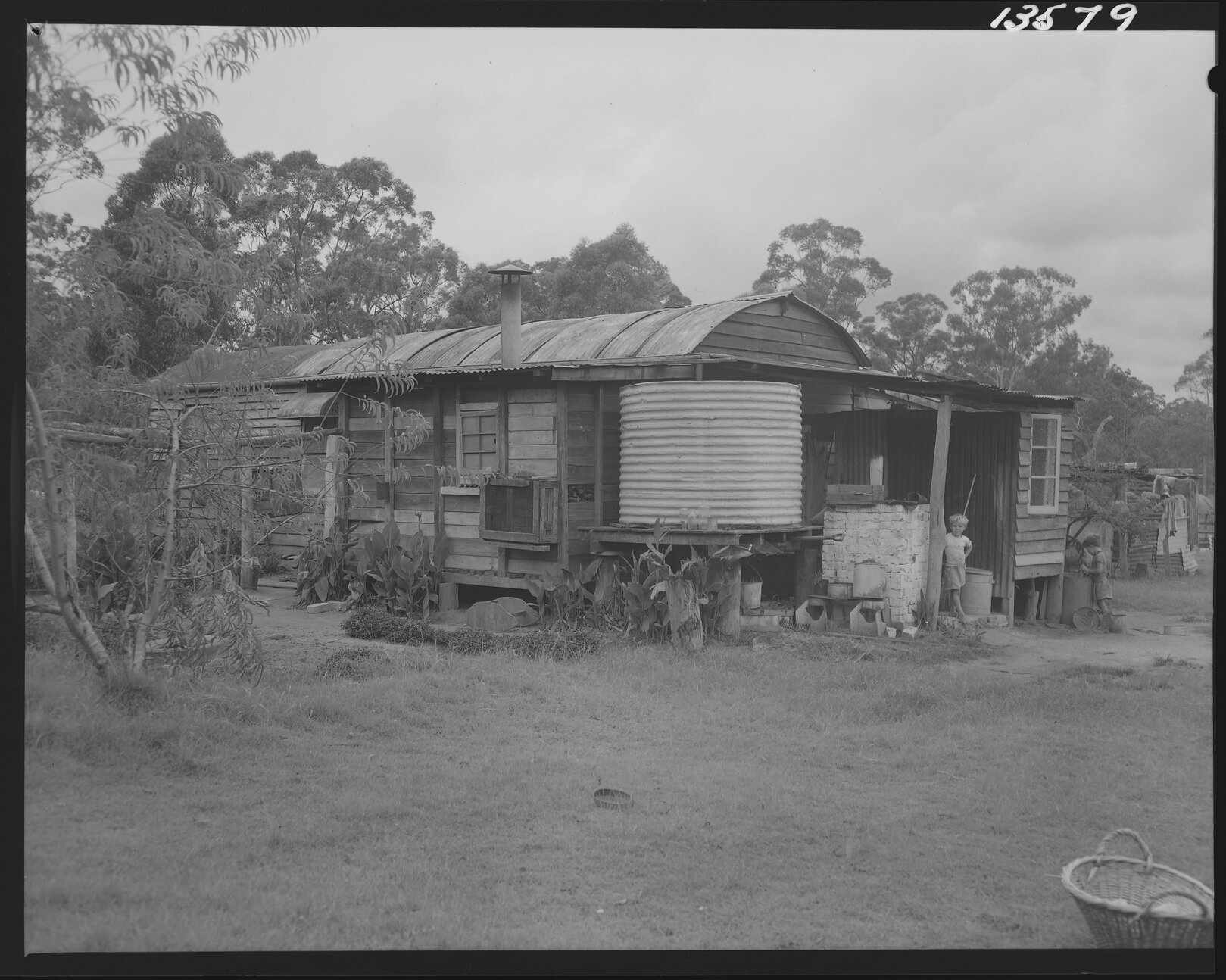 Temporary housing with two young boys, Carole Park and surrounds - 1960