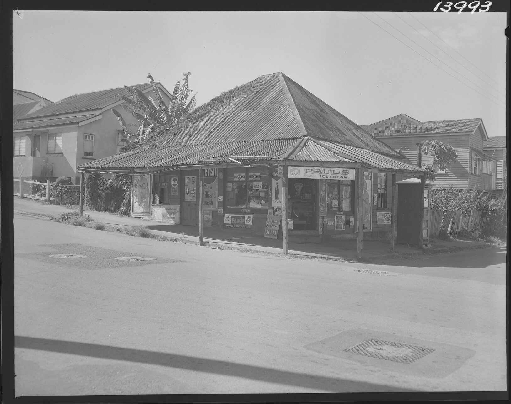 Corner store with pyramid roof and vines on corner of Heal and Clay Street, New Farm - 1960