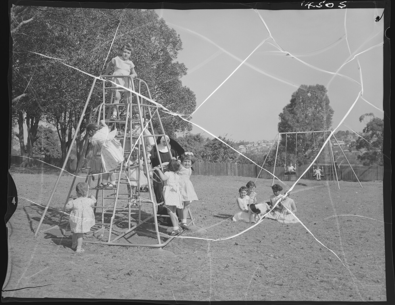 Children playing rugby and on equipment at Catholic children's home - 1960