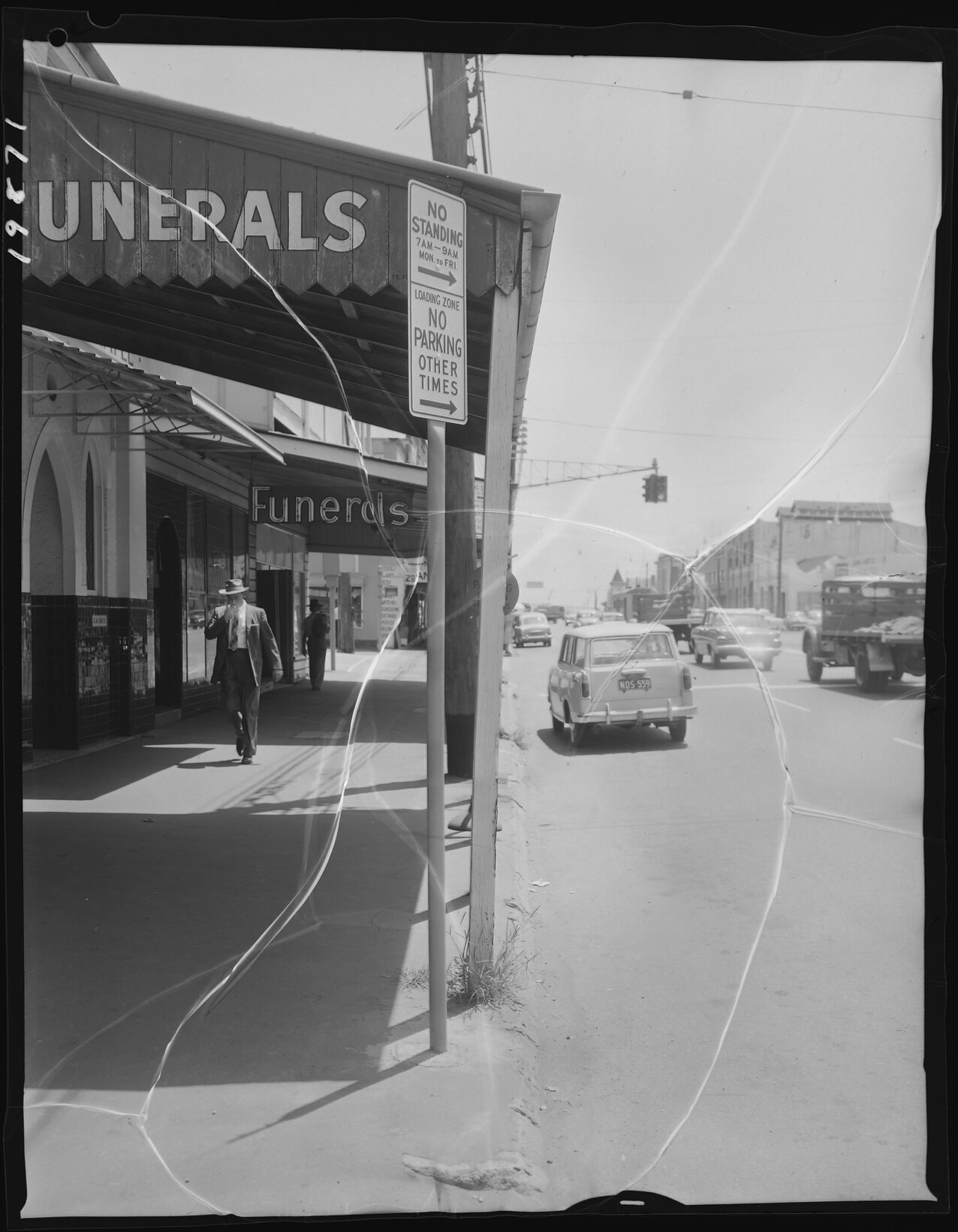 Man walking down Vulture Street, smoking outside funeral parlour, West End - 1963