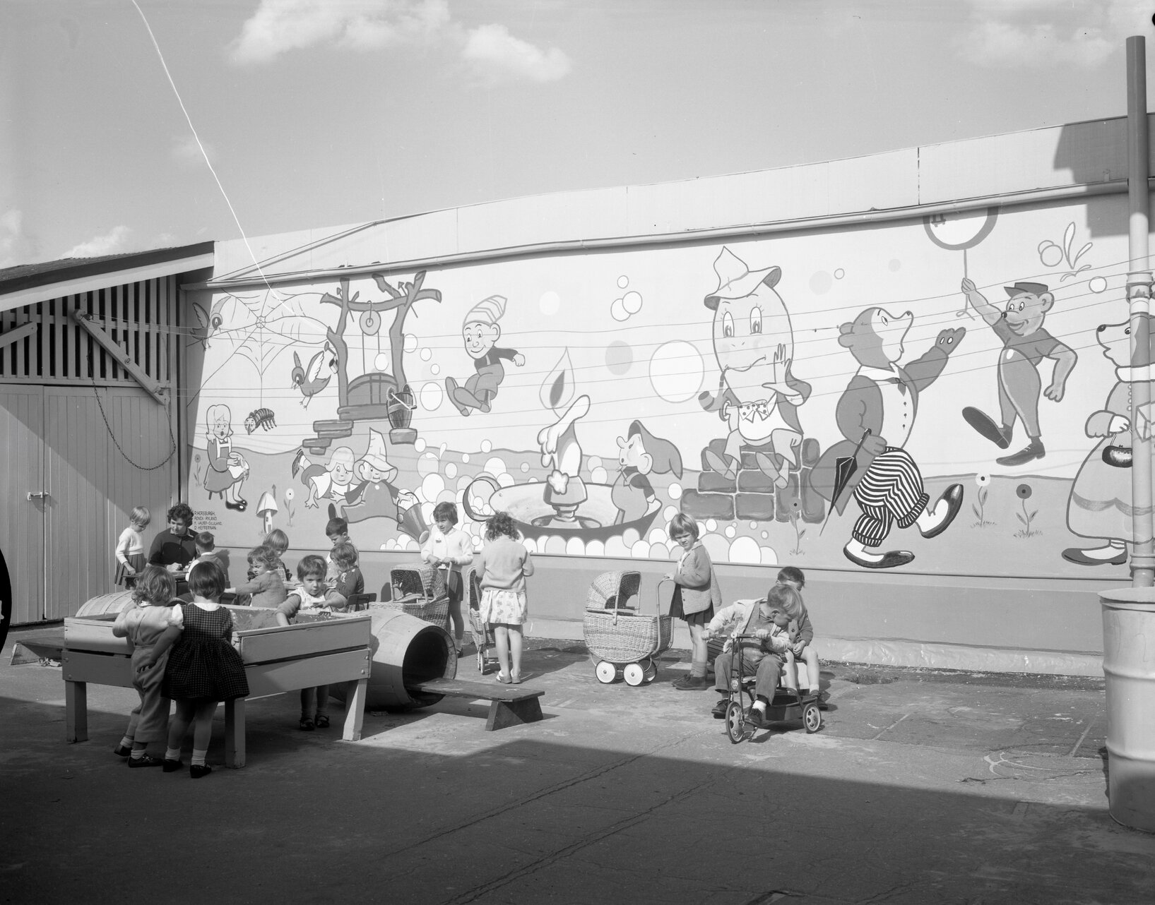 Children playing in front of wall mural, Civic Day Nursery, City Hall, Brisbane City - 1963
