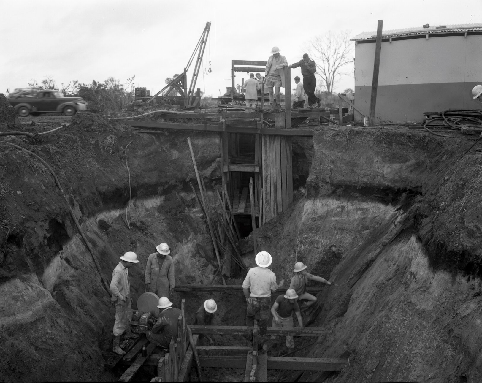 Workers in stages of constructing sewerage main, Nudgee Road, Northgate- 1963