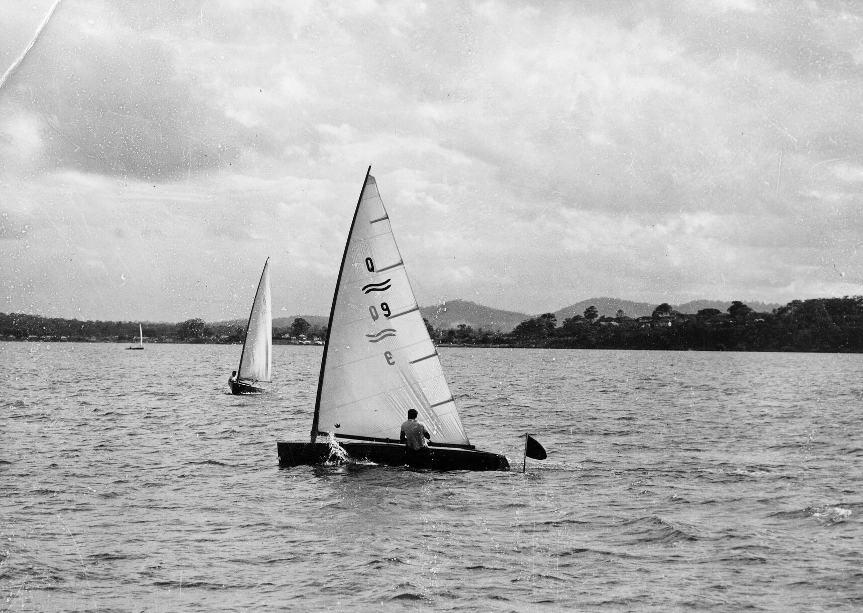 Ron Jenyns piloting a dinghy in Moreton Bay, Wynnum - 1958