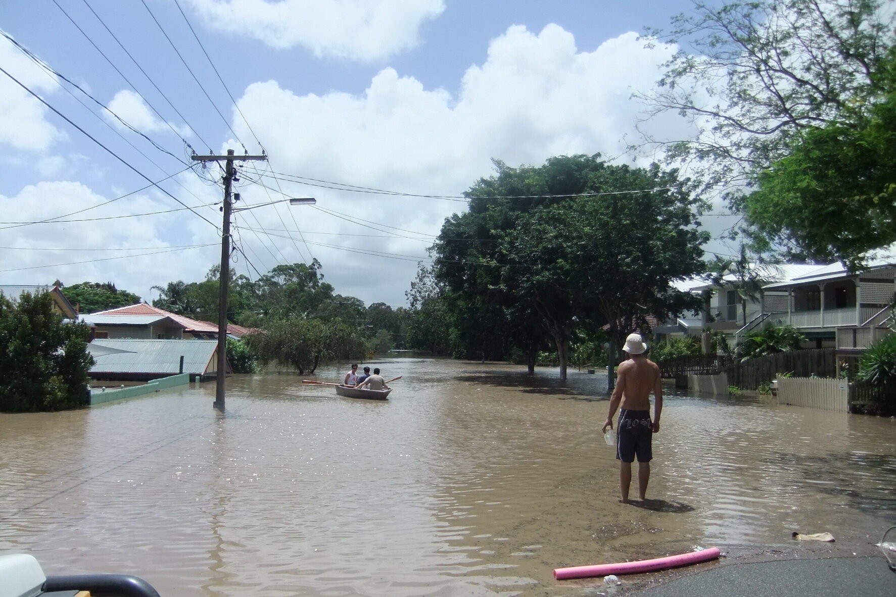 Graceville residents rowing down the street during flood - 2011