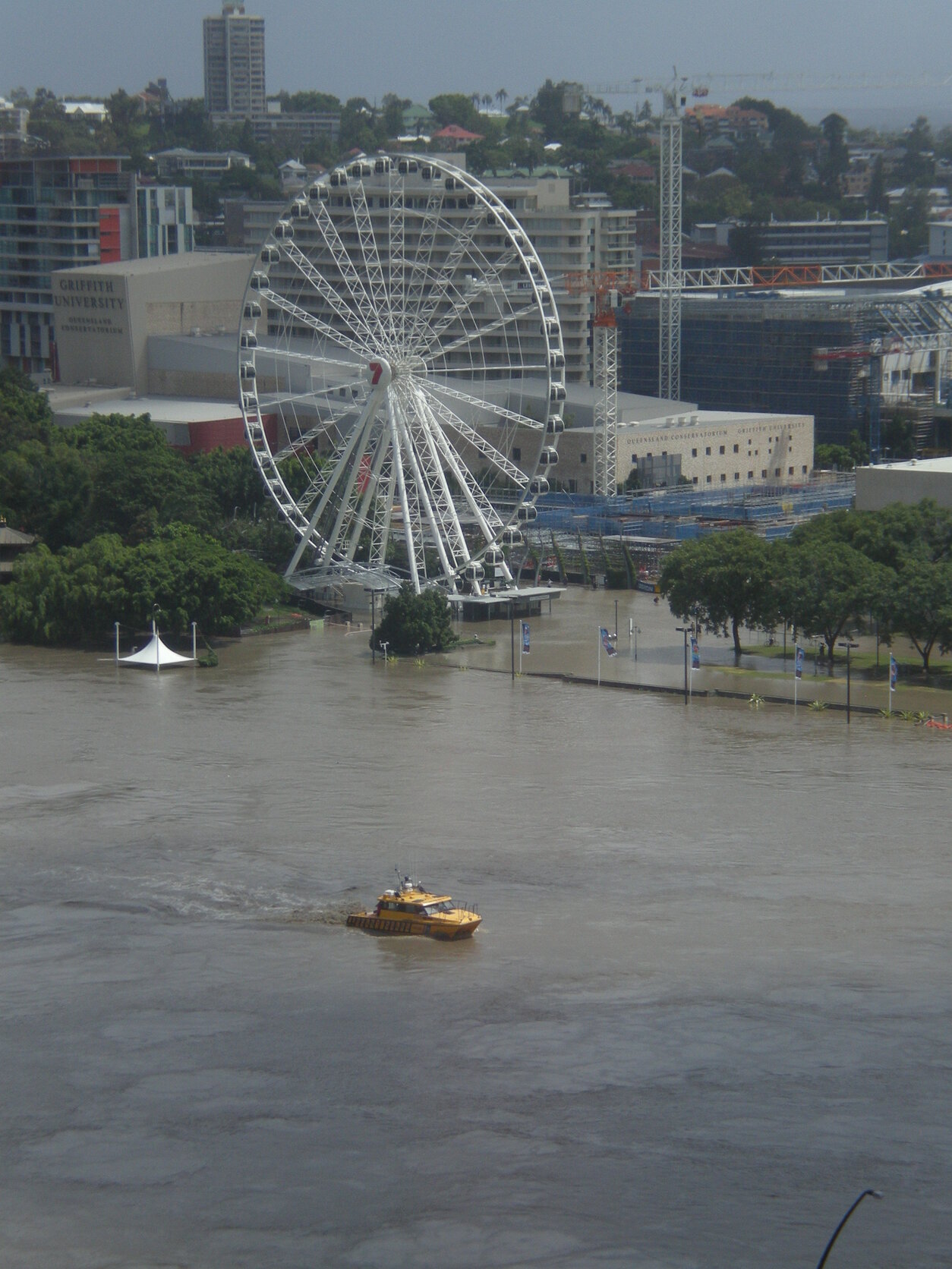 Wheel of Brisbane above floodwaters and rescue boat - South Bank, South Brisbane - 2011