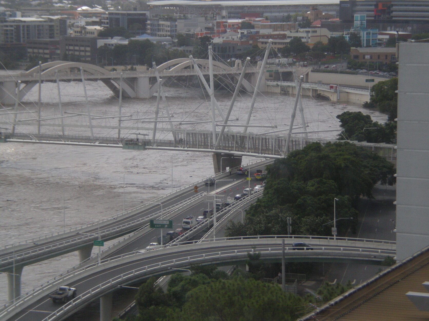 Brisbane River floodwaters raging below the Riverside Expressway, William Jolly Bridge, and Kurilpa Bridge, Brisbane City - 2011