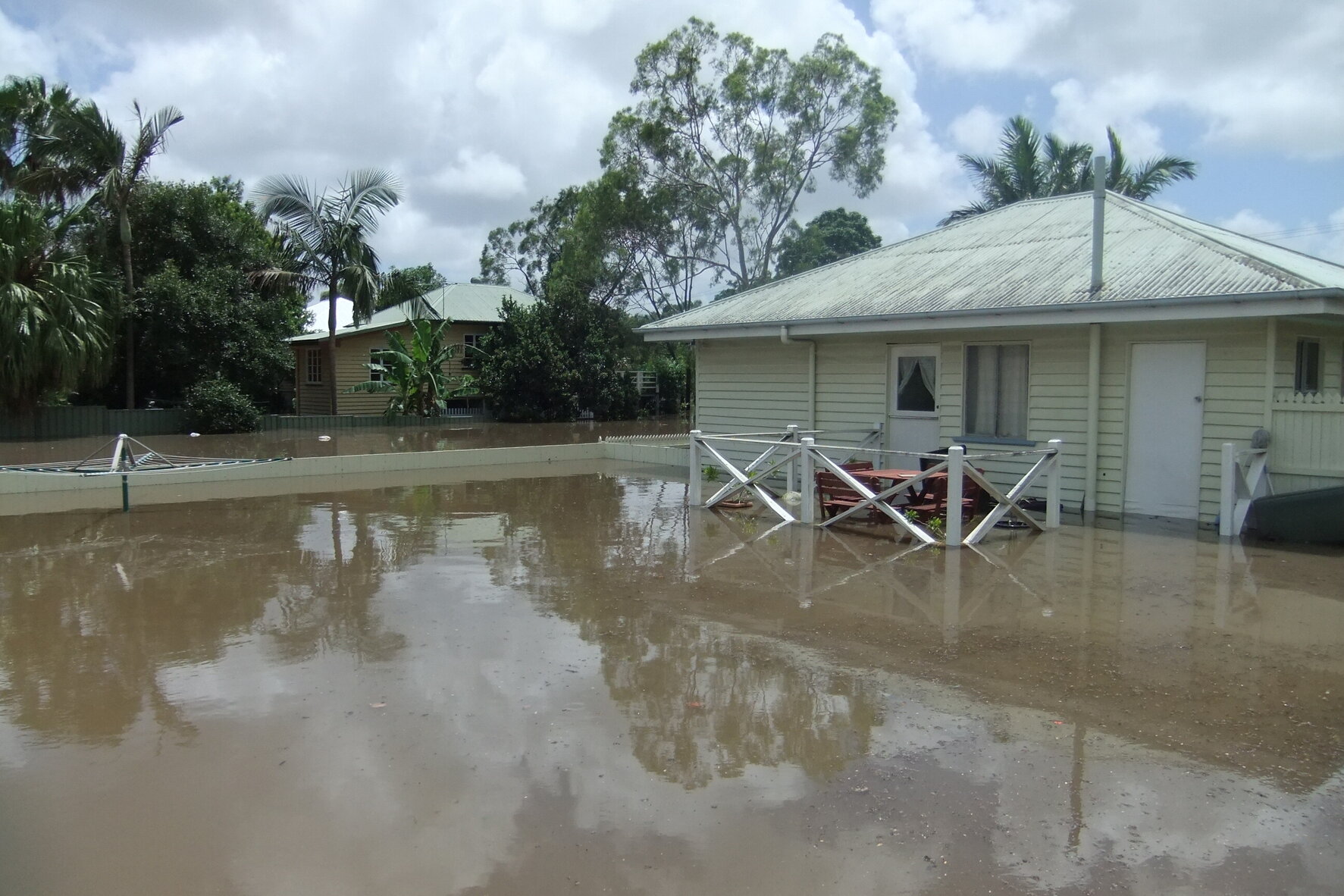 Flood nearly reaching top of fenceline in Coleman Street, Graceville - 2011