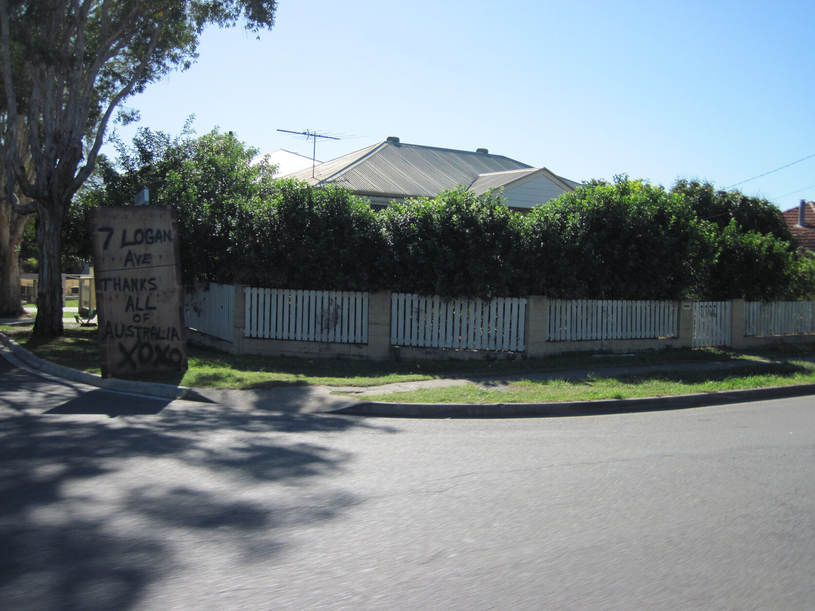 Plywood sign on the corner of Oxley Road and Logan Avenue after floods, reading "7 Logan Ave - Thanks all of Australia xoxo", Oxley 2011
