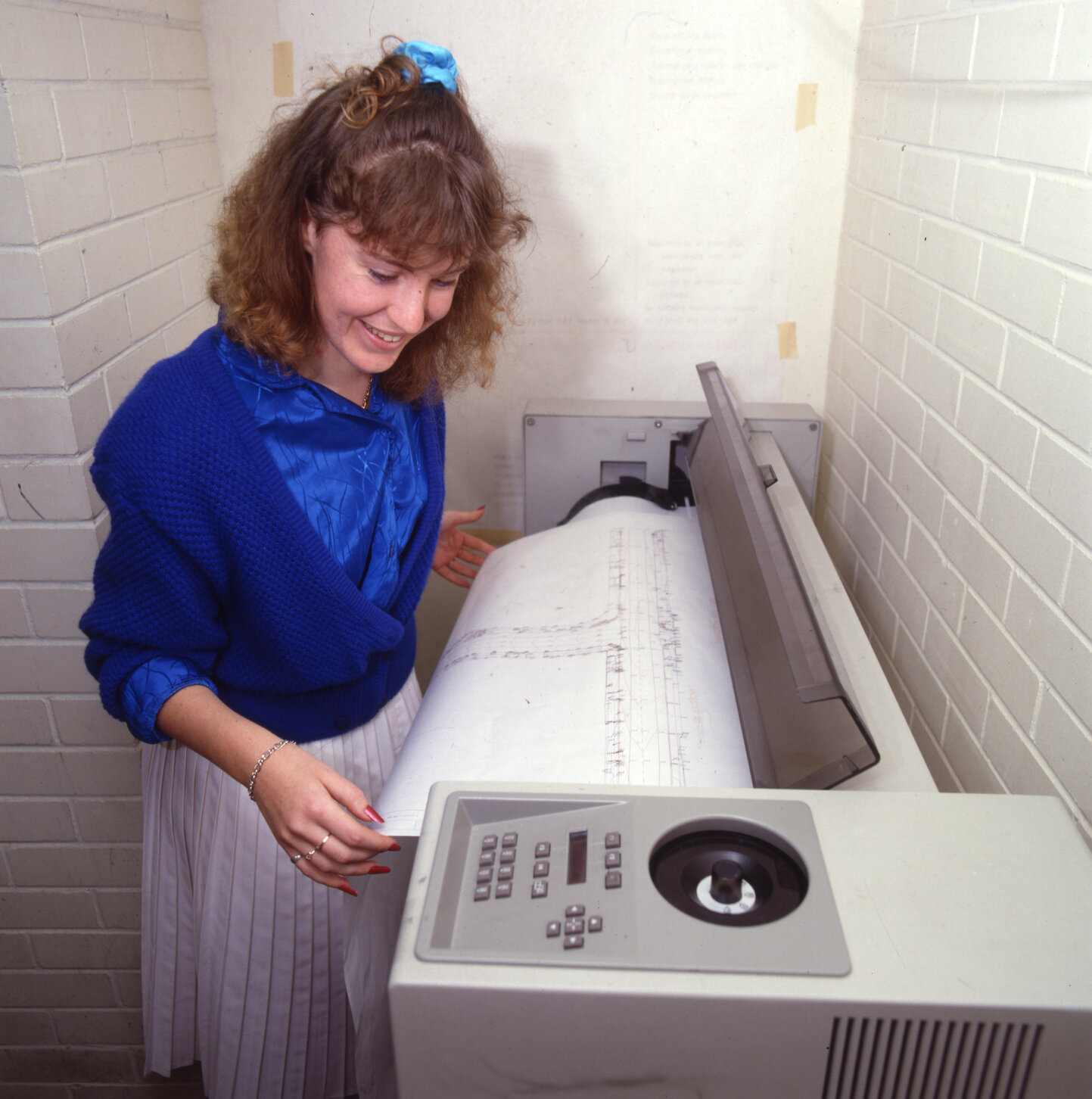 Council worker examining map plotter, 1988