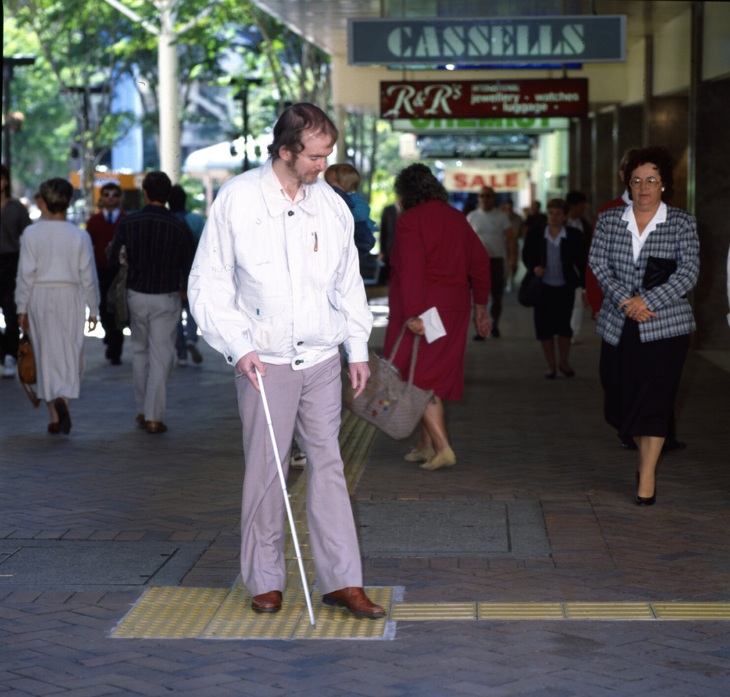 Vision impaired man using braille trail in Queen Street Mall - 1995