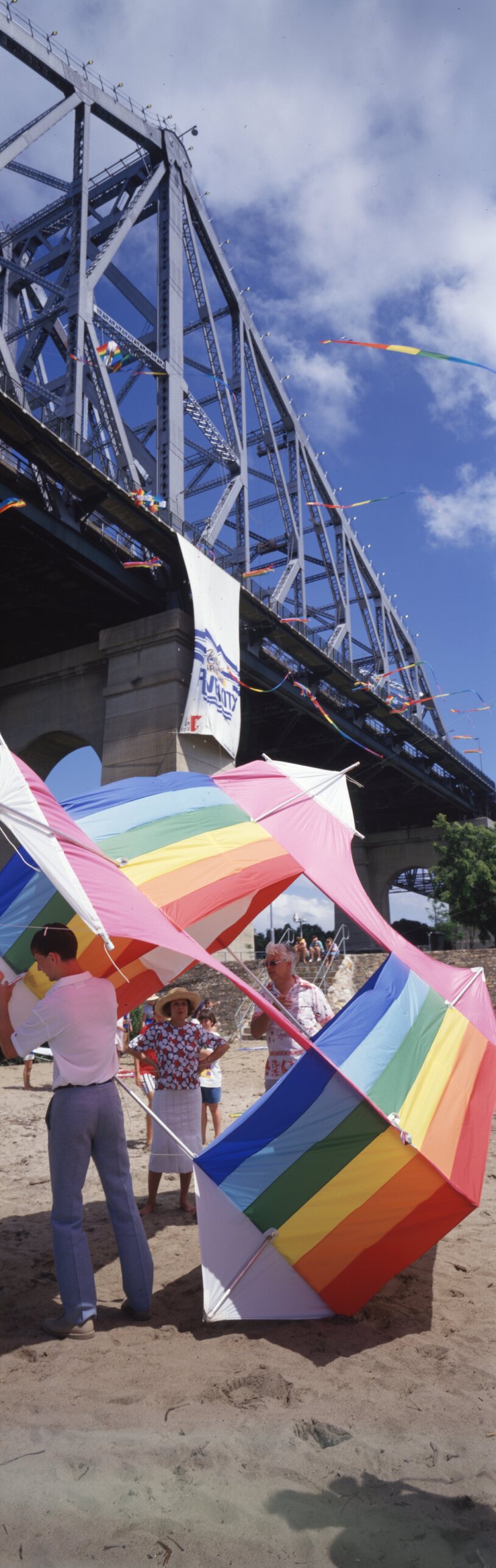 Lord Mayor Sallyanne Atkinson oversees erection of rainbow box kite under the Story Bridge for Brisbane's Year of the River events - 1987