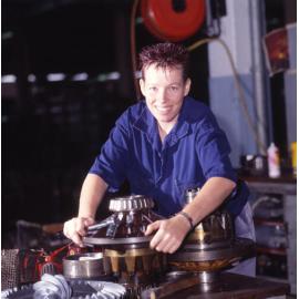 Female Mechanic Repairing Bus Wheel Bearing