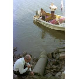 Council engineer inspects water pipe on Milton Reach with onlookers, Milton - 1975