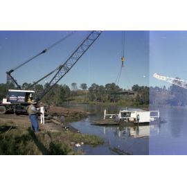 Moggill Ferry being lifted by crane from river for maintenance - 1978