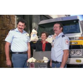 Lord Mayor Sallyanne Atkinson holding bags of money, a donation by ANZ and Brambles Security for the 1992 Olympic bid - 1986