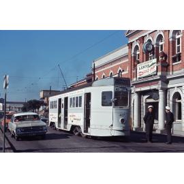 Tram drivers talking outside South Brisbane Station with tram No. 417 - 1964